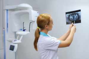 Dentist observing a digital x-ray.