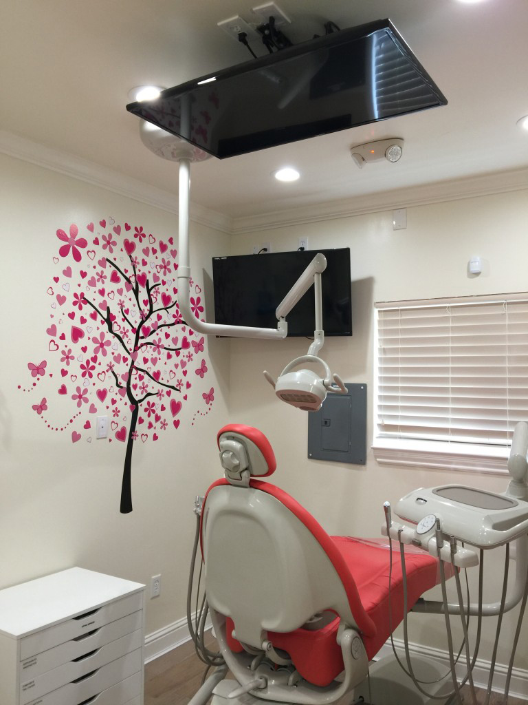 iSmile Dental office children's exam room with television on the ceiling