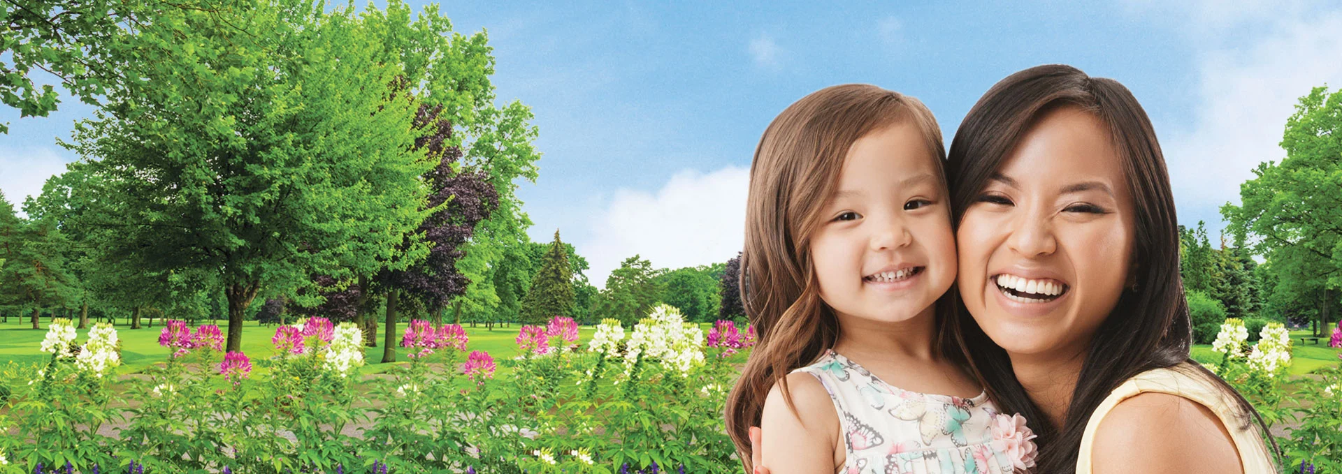Woman hugging young girl in filed of flowers.
